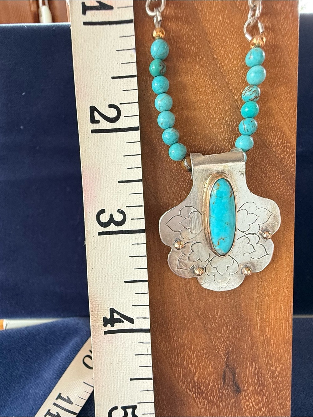 Turquoise Bead Necklace with Silver Floral Pendant with Turquoise center stone.
